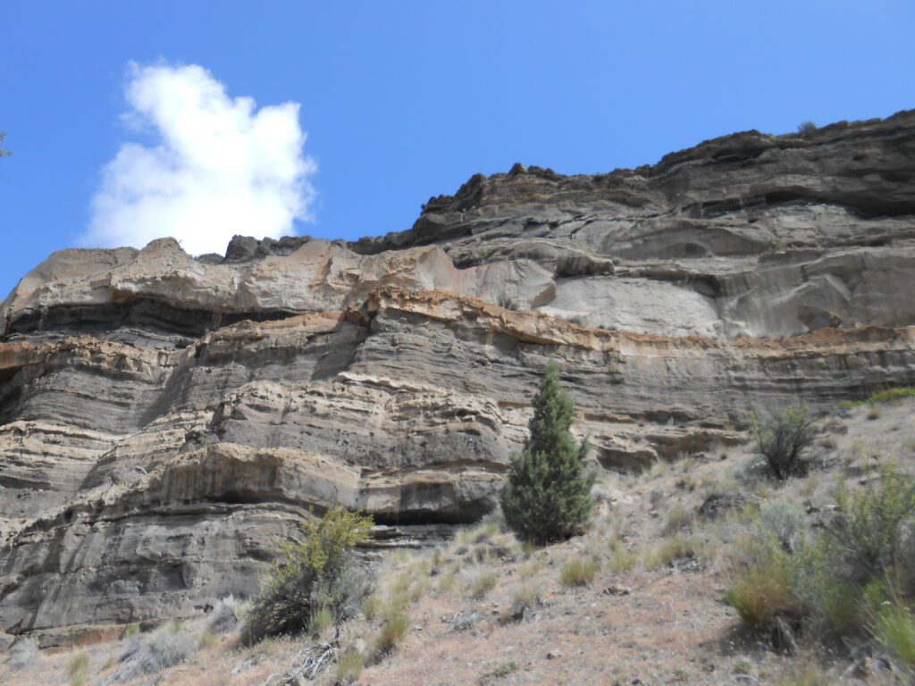 multi levels of rock and earth, cliff, blue sky